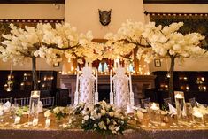 a table with flowers and candles on it