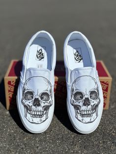 Custom Skull head on white Vans slip on shoes.  We source each pair of shoes brand new directly from Vans. The ink is permanent and will never come off. This price includes everything: shoes, artwork, and shipping. Thanks for stopping by our Etsy shop! Please message us with any questions. Made in USA. Sizes listed are in US sizing scale. If you have any issues with your order, please feel free to reach out to us and we will be more than glad to help you! Note: Blvd Custom is in no way affiliated with any of the shoe brands or companies that are featured on our website. Each pair of shoes is ordered lawfully bought at retail price. White Slip-on Custom Sneakers For Skateboarding, Custom Slip On Vans, Shoes Artwork, Vans Slip On Shoes, Slip On Vans, Skeleton Skull, White Vans, Vans Slip On, Custom Vans