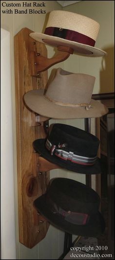 hats are stacked on top of each other in a closet with wooden shelves and hooks