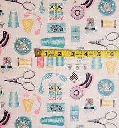 a ruler and some sewing supplies on a white background with blue, pink, yellow, and green designs