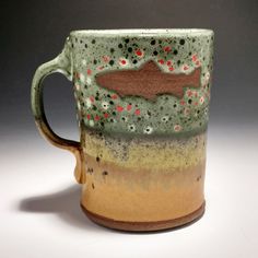 a ceramic mug with a fish on it