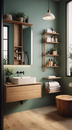 a bathroom with green walls and wooden shelves on the wall, along with a white sink