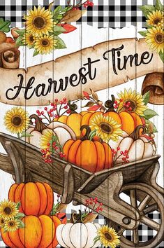 a wooden sign that says harvest time with pumpkins and sunflowers in a wheelbarrow