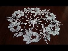 a white flower design on a wooden table