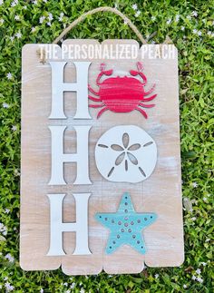 a wooden sign that says the personalized beach with crab, starfish and shell