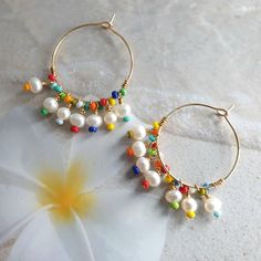 Rainbow earrings, colorful earrings, beach jewelry, big hoop earrings, modern jewelry, mothers day gift, freshwater pearl hoop earrings, wire wrapped earrings, cute earrings, summer jewelry, unique earrings, rainbow jewelry, 24K gold filled hoop. Modern trendy beach jewelry. These rainbow earrings look like a piece you might pick up on vacation. Wear them with everything from a T-shirt and jeans to your favorite swimsuit. HIGH QUALITY MATERIALS / SIZE 24-karat gold filled 20mm hoops wire wrapped Fun Rainbow Earrings For Beach, Colorful Dangle Hoop Earrings For Summer, Beach Hoop Earrings Wire Wrapped, Beach Hoop Earrings With Wire Wrapping, Beach Wire Wrapped Hoop Earrings, Summer Gift Wire Wrapped Hoop Earrings, Colorful Hoop Earrings For The Beach, Colorful Bohemian Hoop Earrings For The Beach, Rainbow Drop Earrings For The Beach