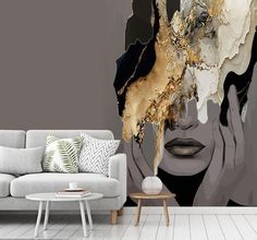 a living room with a couch, coffee table and wall mural