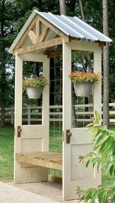 a small wooden structure with potted plants on it