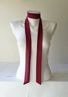 This burgundy skinny scarf is made of an beautiful crepe chiffon fabric. It is sewn with a double layer, no raw edges or open seams. It has angled ends. You can wrap skinny scarf around your neck in one of many different ways. It can be use as a headband and belt also. Details: ♥ The skinny scarf has been sewn in double layer, no raw edges or open seams. ♥ Material: Crepe chiffon fabric (lightweight polyester) ♥ Color: Burgundy ♥ Measurements; ~ Length: 63 inches  ~ Width: 1.5 inches  ♥ Care: Ha Womens Neck Tie, Scarf Choker, Narrow Scarf, Mini Scarf, Chiffon Bow, Tie For Women, Scarf Outfit, Small Scarf, Women Ties