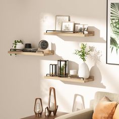 three wooden shelves on the wall above a couch