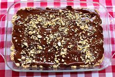 a chocolate dessert in a glass dish on a red and white checkered tablecloth