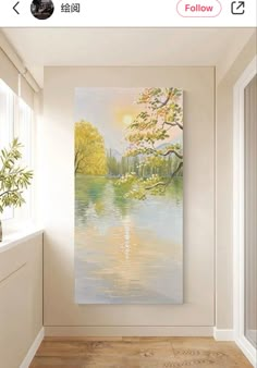 a painting hanging on the wall next to a window in a room with wood flooring