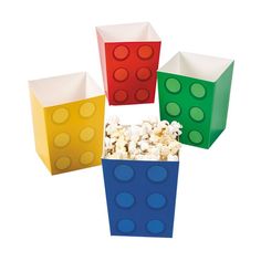 four different colored boxes filled with popcorn on top of each other and one is made out of lego blocks