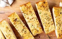 garlic bread sticks on a wooden cutting board