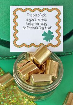 a glass jar filled with gold bars next to a green pot full of gold coins