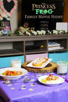 the princess frog family movie night menu is displayed on a purple tablecloth in front of a television