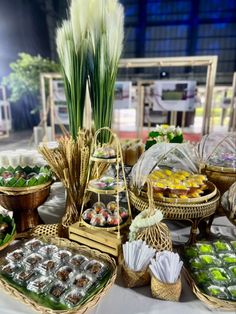 a table topped with lots of baskets filled with food