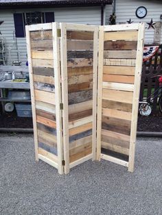 an outdoor room divider made out of pallet wood