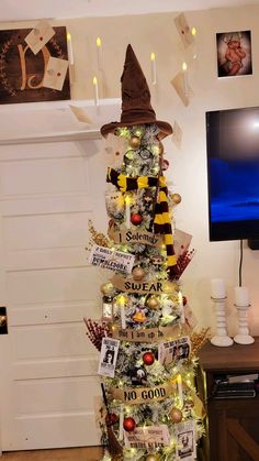 a decorated christmas tree with harry potter's hat and hogwarts on it