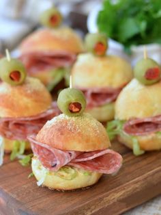 mini sandwiches with olives and ham on them