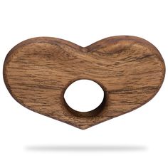 a wooden heart shaped object on a white background