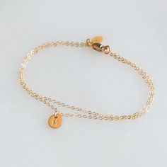 Our Double Chain Bracelet comes in silver, rose or gold chain options. Two sparkling chains for a minimal and chic look for everyday. Adorned with a tiny initial disc for that extra special touch.  Makes the perfect gift too! D E T A I L S -Two layers of dainty link chain -Tiny 6mm initial disc.  -High quality 14kt gold filled or sterling silver - not plated. LENGTH - Please select from the drop down selection. - Fits most sizing: 6.0 inches extra small 6.5 inches small 7.0 inches medium 7.5 inches large  CUSTOM HAND STAMPING  -Hand stamped  -One letter in Uppercase block or script font  -Can also be a symbol  HOW TO PERSONALIZE   -kindly leave your details in the note to seller box that will show up after you add the item to your cart.  ∙ EXTRA LOVE ∙ Crafted and curated just for you in t Dainty Rose Gold Stainless Steel Bracelets, Minimalist Charm Bracelet Jewelry, Minimalist Delicate Chain Jewelry For Friendship, Minimalist Charms Bracelet Jewelry, Simple Personalized Jewelry For Friendship, Personalized Simple Jewelry For Friendship, Minimalist Charms Bracelet, Minimalist Chain Bracelet With Charms As Gift, Dainty Rose Gold Charm Bracelet With Adjustable Chain