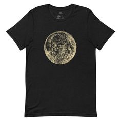 a black t - shirt with an image of the moon in gold foil on it