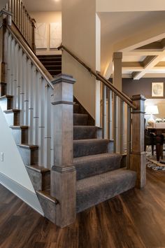 the stairs in this house are made of wood and metal, with carpeted flooring