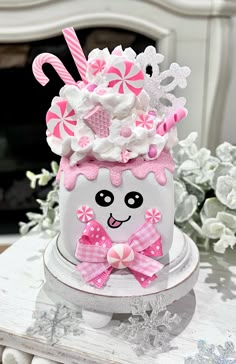 a birthday cake decorated with pink and white decorations