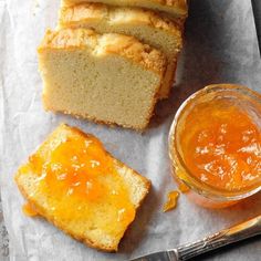 slices of bread, jam and butter on a piece of parchment paper