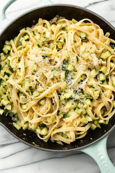 a skillet filled with pasta and broccoli