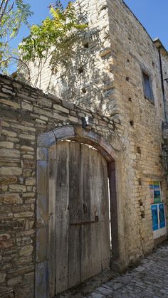 an old stone building with a wooden door