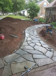 a stone path in the middle of a yard