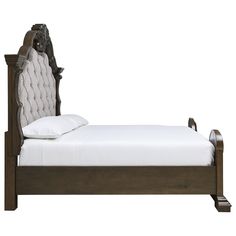 a bed with a wooden frame and headboard, made in the style of an old fashioned