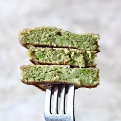 three pieces of cake sitting on top of each other with a fork in front of them