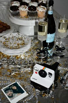 a table topped with cupcakes and champagne