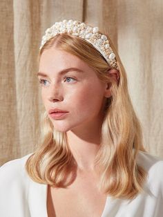 a woman with blonde hair wearing a pearl headband