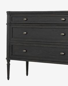 a black dresser with three drawers and two handles on the top, in front of a white background