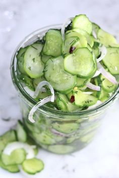 cucumber slices and onions in a glass jar