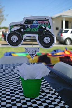 a monster truck cupcake on top of a table