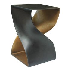 a modern metal and wood side table with curved edges on an isolated white background for display