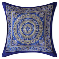 a blue and gold decorative pillow on a white background