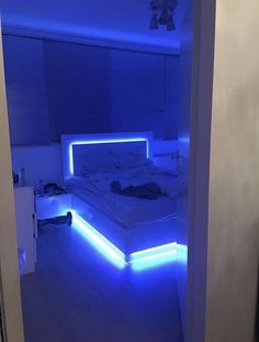 a bed with blue lights in a room