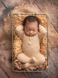 a newborn baby is posed in a basket with his hands on his head, and the caption reads instagram