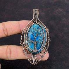 Note : Due to the natural formation of this gemstone. Slight variation in design and color are to be expected.  Tree Of Life Neon Apatite Pendant Copper Wire Wrapped Pendant Gemstone Copper Jewelry Handmade Pendant Tree Of Life Jewelry Anniversary Gift Handmade Copper Pendant SKU : VFWP-933 Gemstone : Neon Apatite Stone Shape : Oval Metal Purity : Copper Pendant Length : 84 MM   Pendant Width : 45 MM It helps suppress the feeling of hunger of the apatite stone. It also supports weaken those who want to weaken. The neon blue color of the apatite stone helps people to increase their intuition and inspiration. a great way to access the Apatite stone benefits because it aligns the mind with a particular goal. Blue Labradorite Jewelry With Large Stone, Handmade Blue Labradorite Gemstones, Turquoise Apatite Wire Wrapped Jewelry, Sapphire Colored Kyanite Jewelry As A Gift, Sapphire Kyanite Jewelry As A Gift, Sapphire Kyanite Jewelry For Gift, Handmade Bohemian Kyanite Jewelry, Chrysocolla Stones Jewelry Gift, Artistic Gemstone Jewelry For Healing