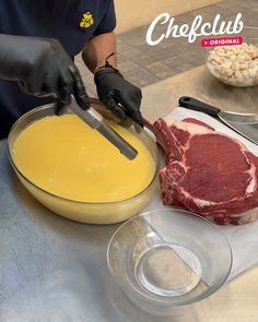 a person in black gloves is cutting up some meat on a table with other ingredients