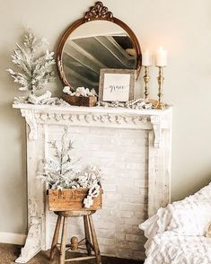 a white fireplace with a mirror above it and flowers in a basket next to it