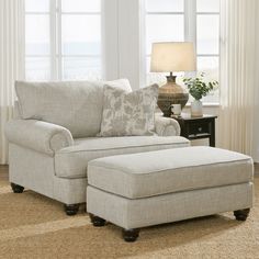 a living room scene with focus on the chair and ottoman