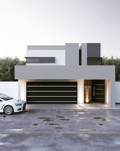 a white car is parked in front of a modern house with lights on the garage