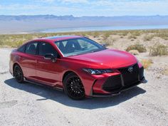 a red sports car parked in the desert